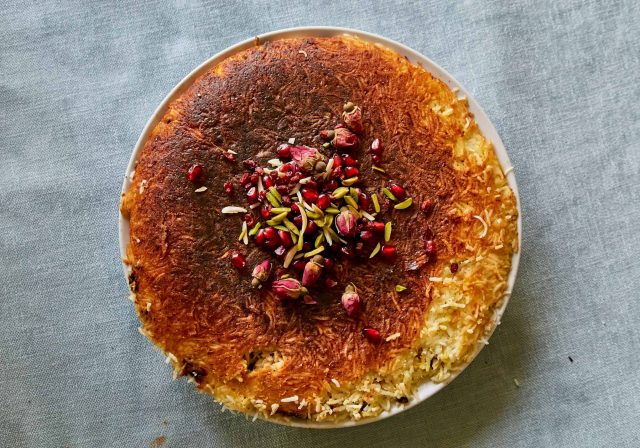Baked rice topped with pistachios, rose petals and pomegranates from Wizzy’s Bapsang Cookbook