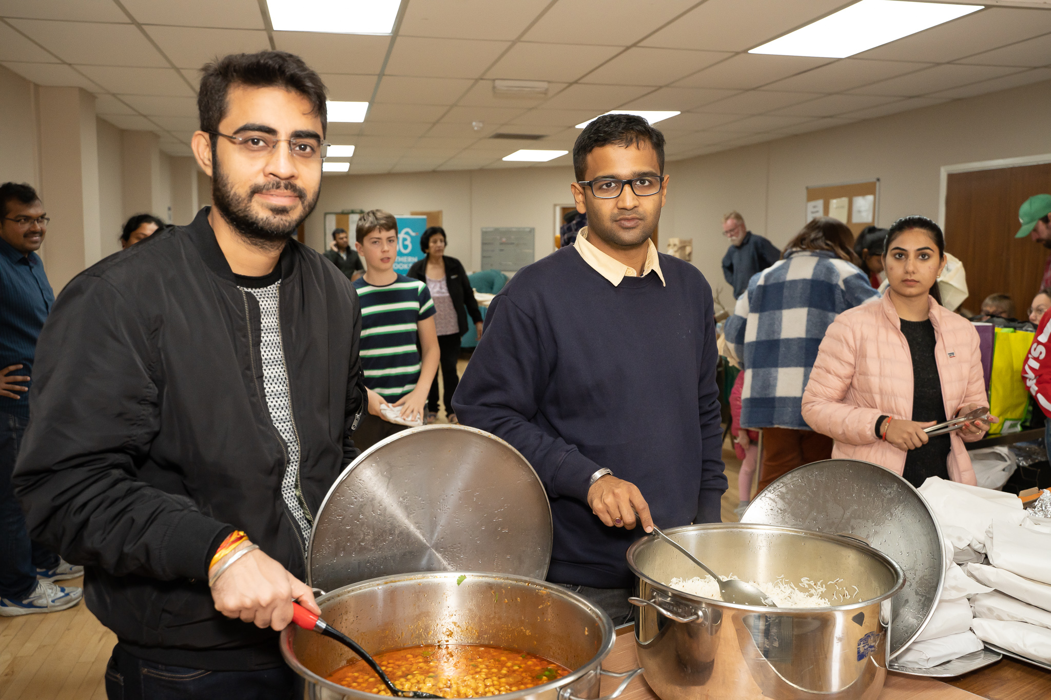 Volunteers serving food at a free community food event organised by The Aura Ion Foundation along with Southern Brooks, Sovereign Housing and Avon Indian Community Association.